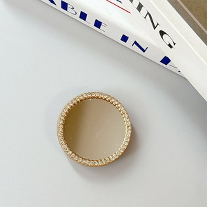 Close-up of square heart mirror phone grip with sparkling rhinestones and champagne gold base