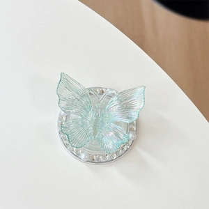 Detailed macro view of 3D colorful resin butterfly phone grip with pearls and rhinestones