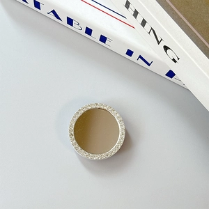 Detail of round phone socket holder with silver rhinestones and a mirror finish surface