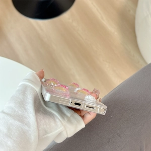 Detail shot of 3D resin flowers on a clear phone case showing precise bottom port cutouts