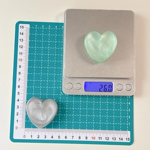 Glitter heart phone socket grip showing 4cm diameter size on a green cutting mat