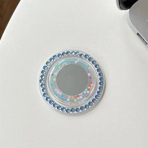 Detail view of a blue glitter phone socket with integrated mirror and rhinestone border