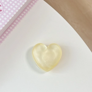 Detailed view of heart-shaped cream yellow glitter grip with pearlescent finish