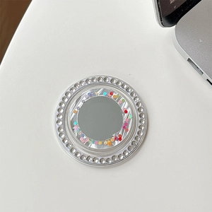 Detail of silver phone grip with rhinestone circle and colorful polka dot mirror