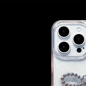Detail of glitter iPhone case featuring a silver bead wrist strap and lens protection