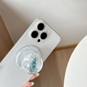 Close-up of 3D snow globe phone socket with a miniature Christmas tree and snow
