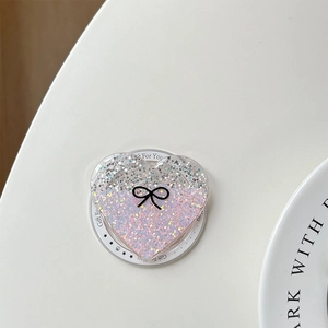 Close-up of glitter heart phone grip with gradient silver to purple sequins and bow