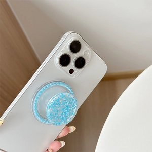 Sparkling blue glitter phone socket grip with shiny sequin finish held by a hand