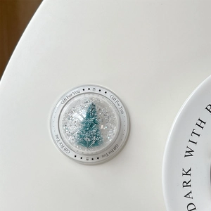 Detailed view of a Christmas tree snow globe phone grip with Gift For You lettering
