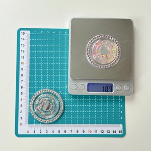 Detailed view of rhinestone phone grip with colorful sequins showing weight and diameter