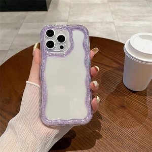Detail of purple wavy glitter phone case with clear back held over a wooden table