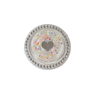 Sparkling crystal magnetic phone grip with colorful heart sequin inlay on white background