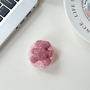 Detail of pink plush phone grip with sparkling rhinestone bear and luxury soft texture