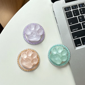 Three magnetic cat paw phone sockets with colorful beads and heart detail on white surface