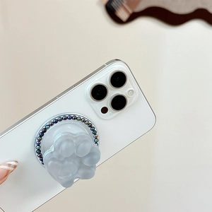 Detail of a matte translucent cat claw phone grip with colorful bead ring decoration