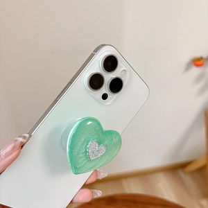 Mint green heart-shaped phone grip with glitter finish and silver diamond accent