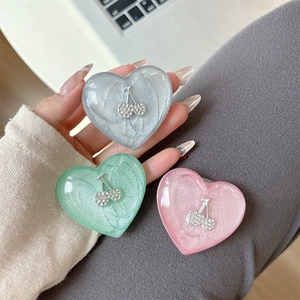 Glittery heart phone grip holders with rhinestone cherry in pink, green and grey tones