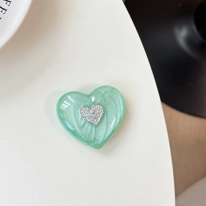 Detail of mint green 3D heart phone socket with pearl finish and silver embossment