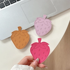 Minimalist strawberry leather phone socket stand in pink, purple, and caramel colors