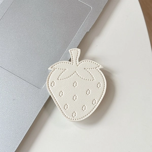 Close-up of strawberry phone grip with fine stitching on off-white faux leather