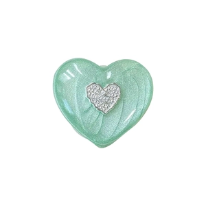 Mint green heart-shaped phone grip with glitter finish and silver heart center