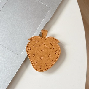 Detail of strawberry leather phone socket showing premium stitching and caramel brown texture