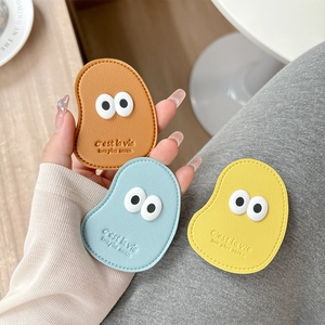 Macro shot of colorful leather phone grips with cute 3D eyes and fine stitched details