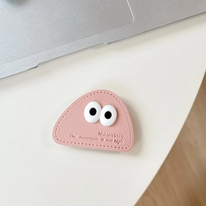 Detailed view of pink leather phone holder featuring cartoon eyes and mountain embossing