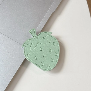 Detailed view of light green leather strawberry phone grip with premium stitching detail