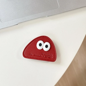Detail of red leather phone socket with cartoon eyes and Mountain text embossing