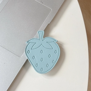 Macro shot of light blue leather strawberry phone grip with fine stitching details