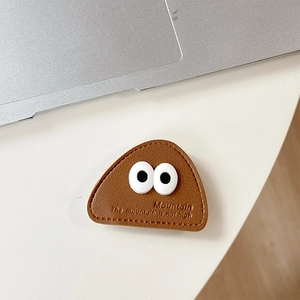 Close-up of leather phone grip featuring big eyes and embossed Mountain lettering