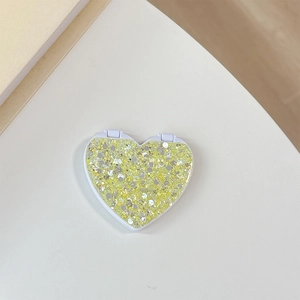Close-up of heart-shaped folding mirror with green and yellow glitter sequins cover