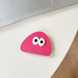 Macro shot of triangular pink leather phone grip with cartoon eyes and stitched edges