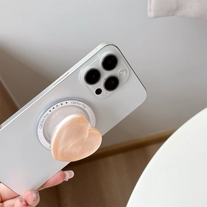 Detail view of a 3D heart-shaped phone grip with Gift For You print on a white iPhone