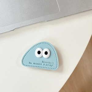 Close-up of light blue leather triangular phone grip with cute eyes and Mountain text