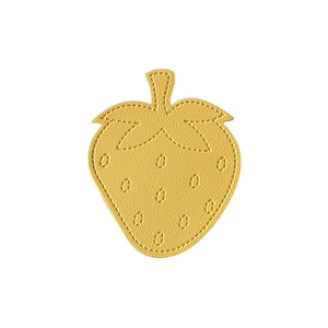 Minimalist yellow leather strawberry phone grip stand with detailed stitching on white base