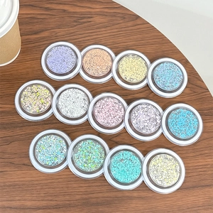 Sparkly glitter round cell phone grip stands in various colors on wooden surface