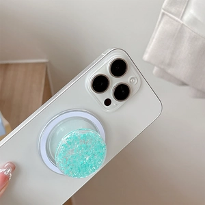 Magnetic glitter phone grip holder with mint green sequins on a white smartphone back