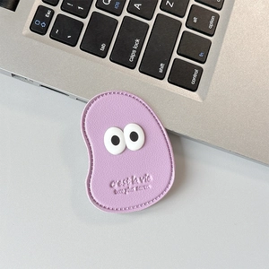 Detail of purple faux leather phone grip with stitch craft and cute cartoon eyes design