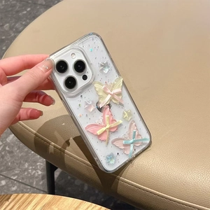 Close-up of clear iPhone case with 3D resin butterflies and sparkling star sequins