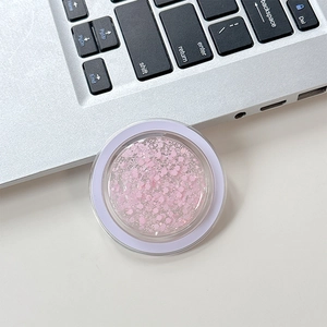 Detail of round phone socket holder with pink hexagonal glitter and purple edges