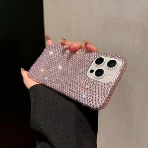 Macro detail of luxury pink rhinestone phone case showing sparkling side profile texture
