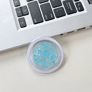 Macro view of clear round phone grip with blue glitter and light purple rim