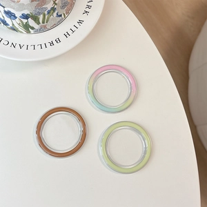 Transparent MagSafe magnetic phone socket base in brown, green, and pink gradient colors