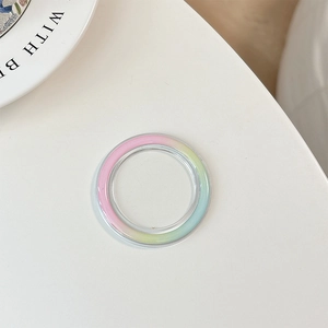 Detail of transparent MagSafe phone grip base featuring pastel macaron gradient colors