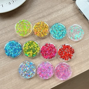 Colorful butterfly sequin circular phone grip stand set on wooden surface background