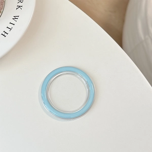 Macro detail of a transparent MagSafe phone socket base with a light blue inner ring