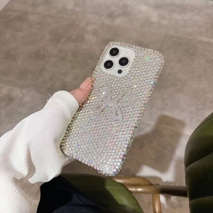 Close-up of a luxury iPhone case featuring a 3D rhinestone bow and full diamond design
