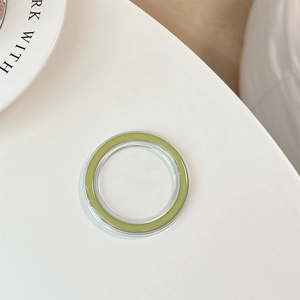 Detail view of transparent MagSafe phone grip base with Morandi green inner ring insert